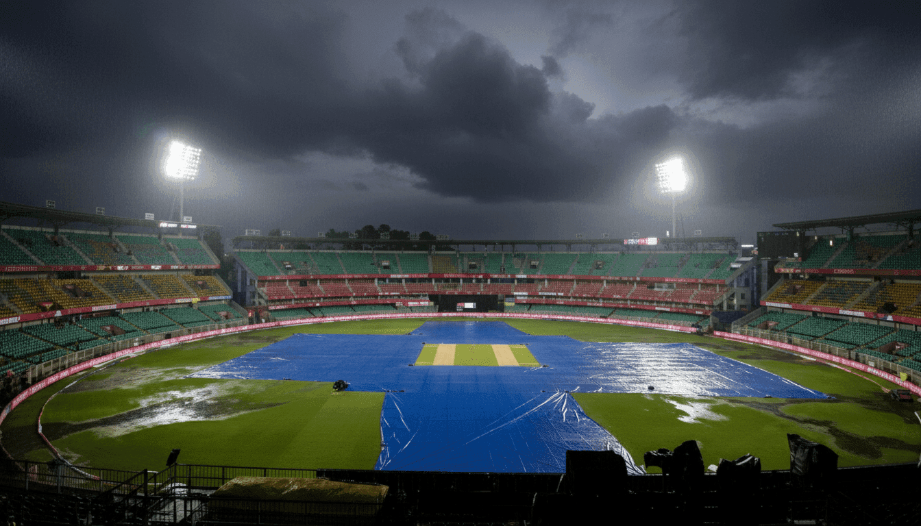 Dark rain clouds over a cricket ground covered with tarpaulins